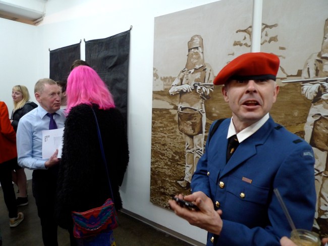 Someone dressed up as Ned Kelly is gunna shoot this guy in the red hat